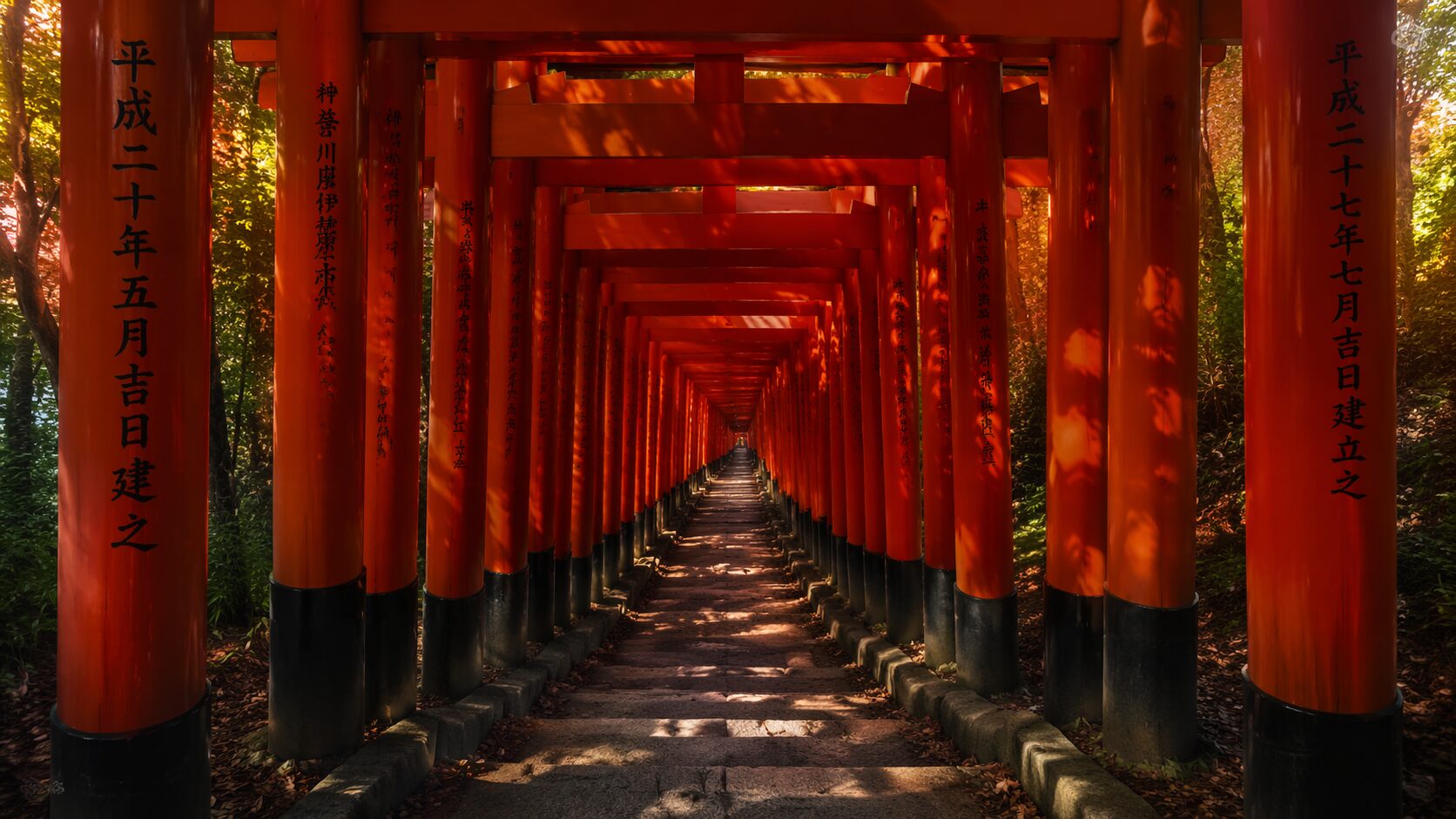 Tunnel of thousands of vermilion torii gates lining the forested path at Fushimi Inari Shrine in Kyoto