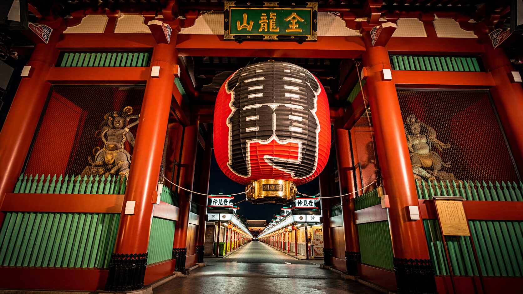 Giant red lantern hanging at Kaminarimon Gate of Senso-ji Temple in Asakusa, Tokyo, illuminated at night