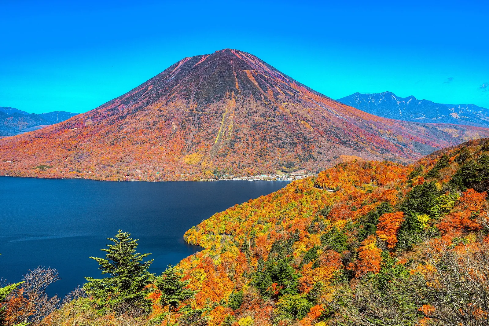 Lake Chuzenji and Mt. Nantai in Nikko, framed by autumn-colored trees